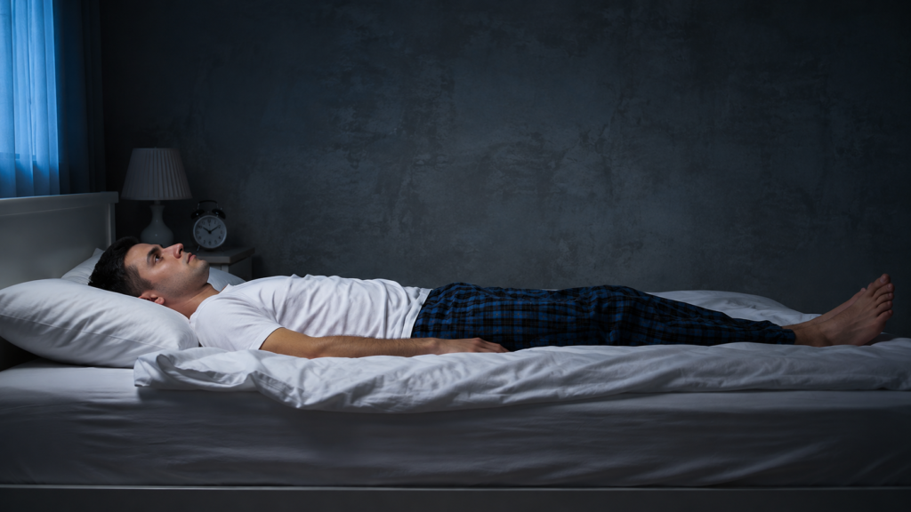 Person experiencing sleep paralysis while awake in bed